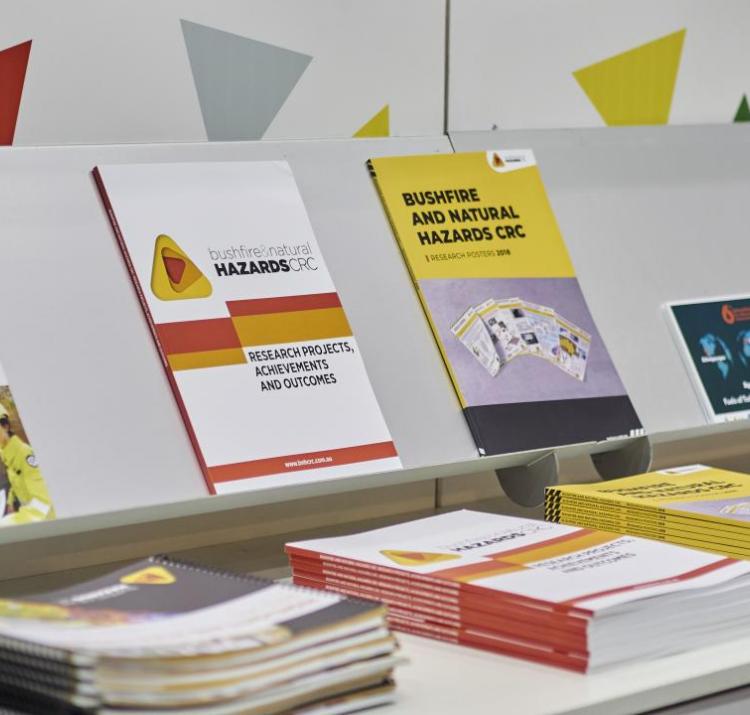 A display of CRC publications at a conference booth is pictured.