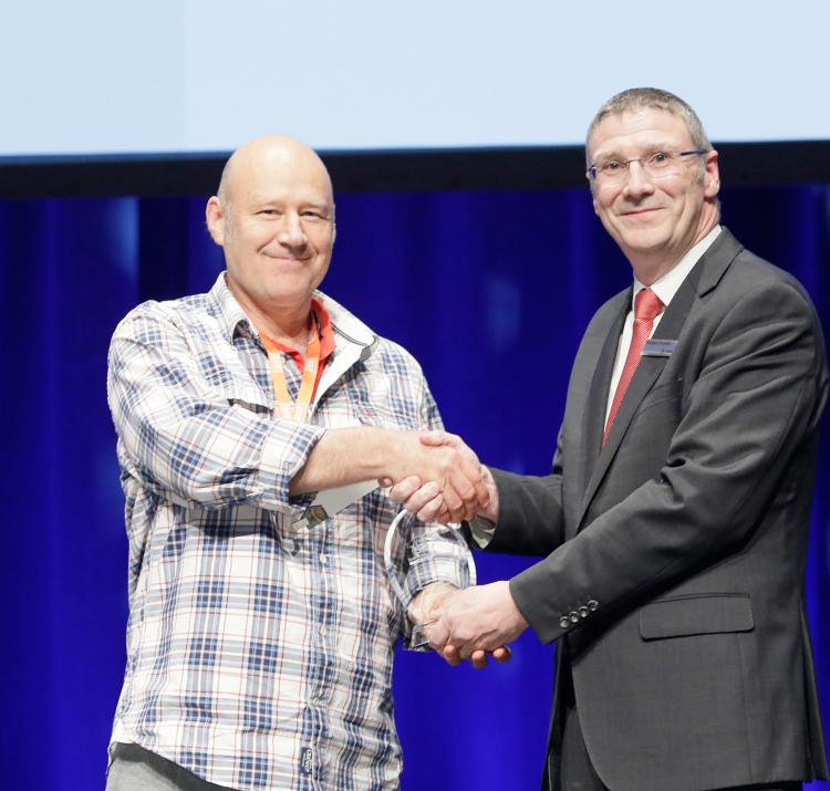 Dr Adam Leavesley accepting the award for Outstanding Achievement in Research Utilisation at AFAC19