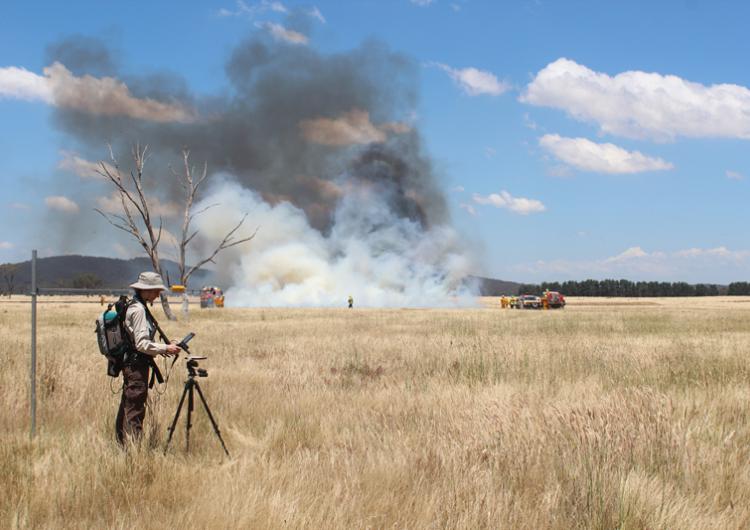 Dr Marta Yebra conducting a grassland fire experiment. Photo: Carolina Luiz