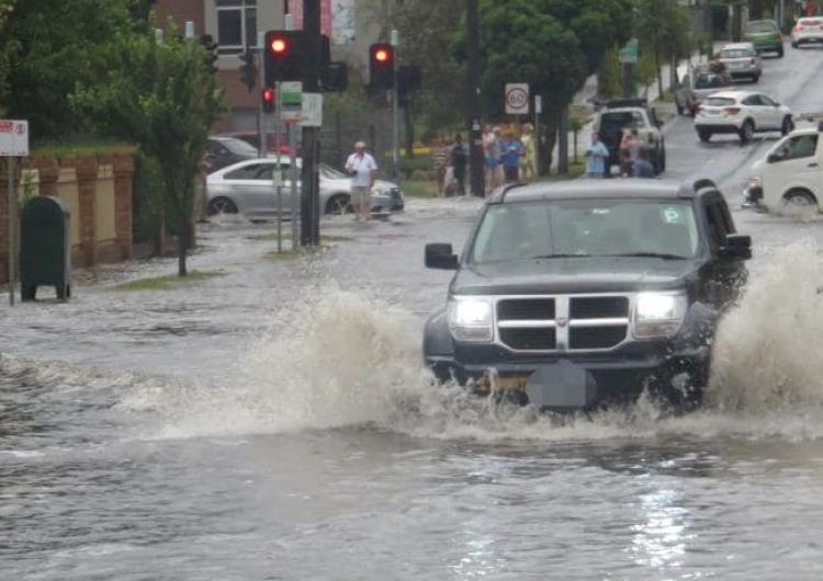 A car trying to make its way through flooding in Hawthorn Rd, Brighton East. Photo: Peter Farrar.