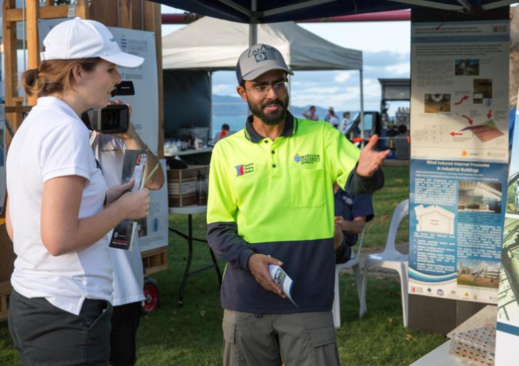 PhD researcher Korah Parackal talks about his research at a cyclone awareness day in Townsville.