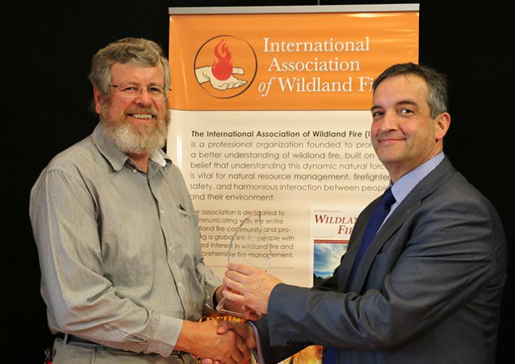 Dr Kevin Tolhurst (left) receives the Ember Award from IAWF Vice-President Alen Slijepcevic.