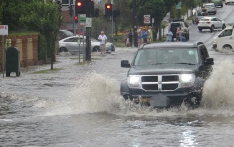 A car trying to make its way through flooding in Hawthorn Rd, Brighton East. Photo: Peter Farrar.
