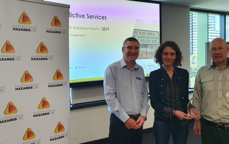 Dr Richard Thornton (left) presenting Dr Marta Yebra (middle) with the 2019 Outstanding Achievement in Research Utilisation award for her research that she has done alongside lead end-user Dr Adam Leavesley (right).
