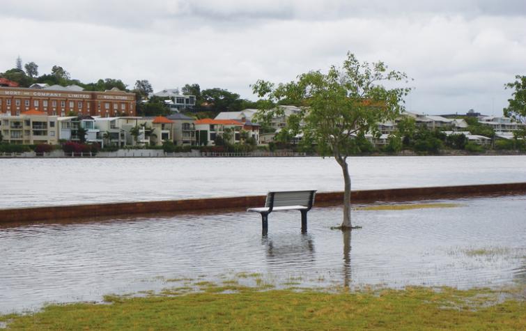 A bench at a park submerged from rising water levels. Photo: Liese Coulter