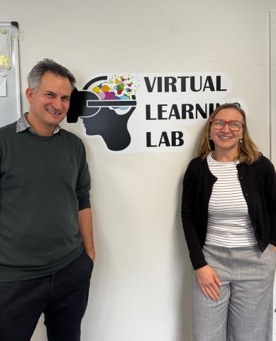 Two people standing in front of sign 'Virtual learning lab'