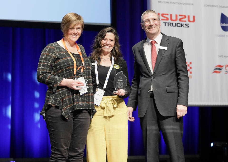 Dr Blythe McLennan from RMIT University and Amanda Lamont from the Australian Institute for Disaster Resilience receiving an award from Bushfire and Natural Hazards CRC CEO Dr Richard Thornton.