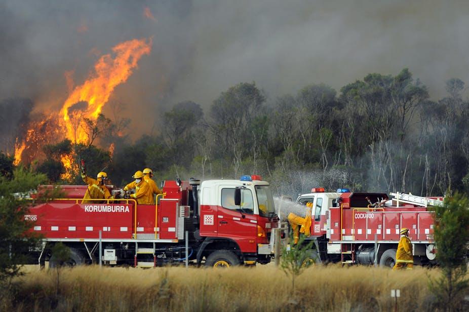 Black Saturday firefighters battling flames in Victoria. When we laud fire fighters as heroes, we fail to acknowledge the ongoing impact of the fires. Photo: Andrew Brownbill