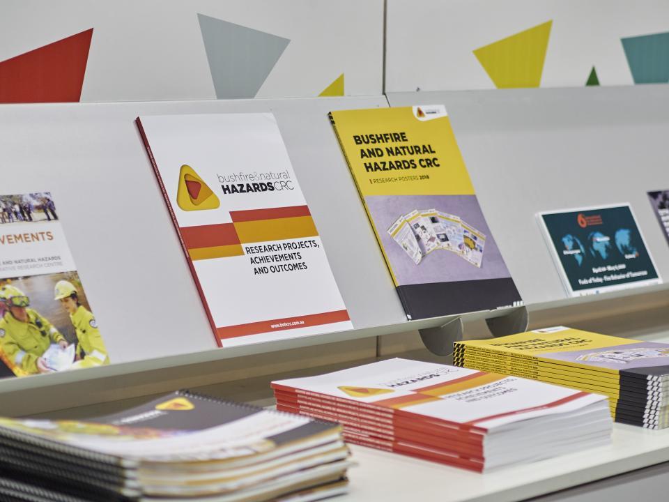 A display of CRC publications at a conference booth is pictured.