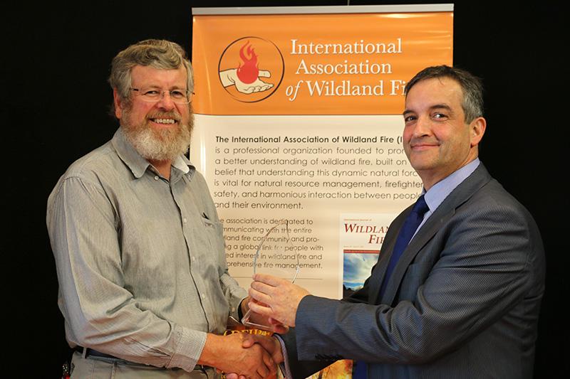 Dr Kevin Tolhurst (left) receives the Ember Award from IAWF Vice-President Alen Slijepcevic.
