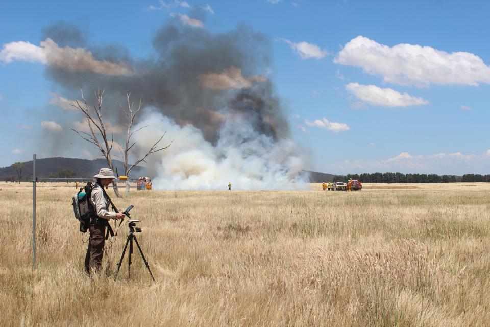 Dr Marta Yebra in the field conducting a grass fire experiment. Photo: Carolina Luiz.