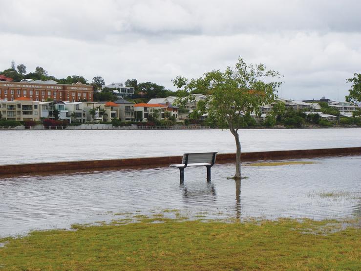 A bench at a park submerged from rising water levels. Photo: Liese Coulter